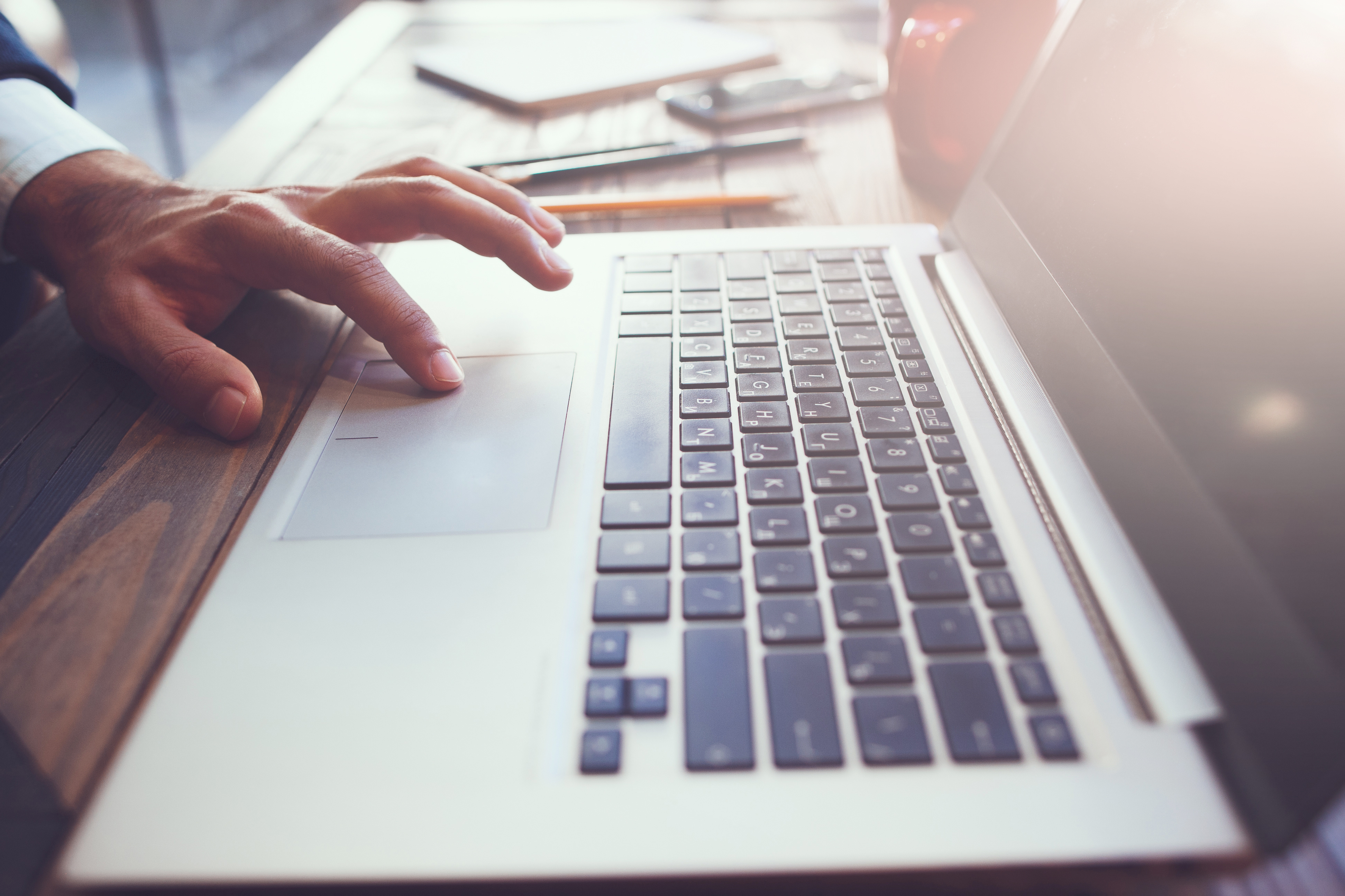 A person using the trackpad of their laptop keyboard.